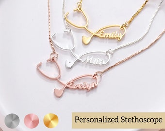 May include: Three gold, silver, and rose gold necklaces with a stethoscope pendant and personalized names "Emily", "Mila", and "Evelyn".