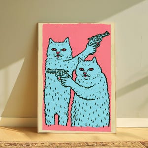 May include: A rectangular art print featuring two light blue cats with red eyes against a solid pink background. Each cat is holding a black revolver, with one cat pointing its weapon upward and the other pointing its weapon forward in a graphic style.