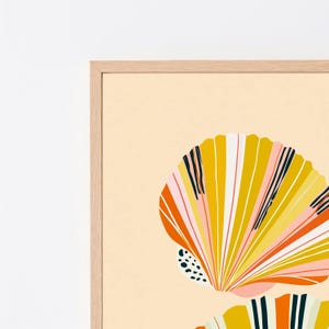 May include: A framed wall art print featuring a stylised illustration of two seashells. The shells are rendered in a palette of mustard yellow, orange, soft pink, and black, set against a solid light beige background within a light wood frame.