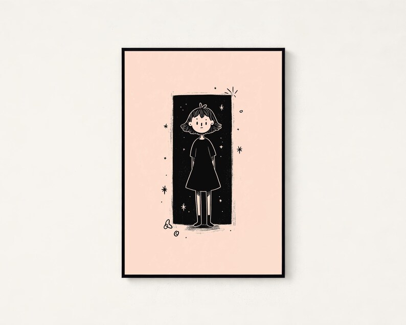 May include: A framed art print featuring a black and white line drawing of a person with short hair wearing a dress, centred within a black rectangular background on a pale pink field, surrounded by small star and circular doodle accents.