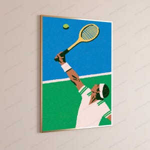 May include: A framed wall art print featuring a stylised illustration of a tennis player in a white shirt with green trim, wearing a white wristband and headband, reaching up with a yellow tennis racket to hit a green tennis ball on a court.