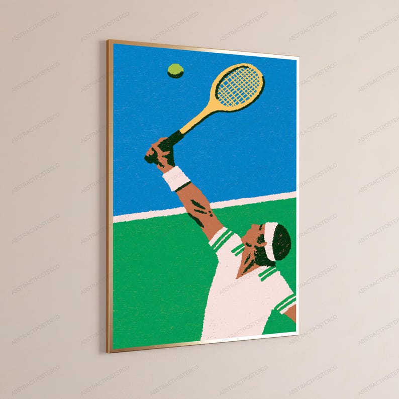 May include: A framed wall art print featuring a stylised illustration of a tennis player in a white shirt with green trim, wearing a white wristband and headband, reaching up with a yellow tennis racket to hit a green tennis ball on a court.