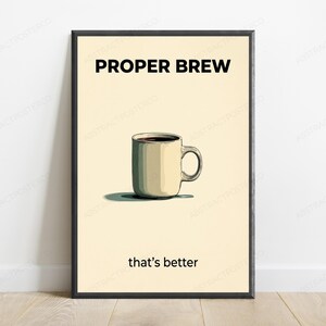 May include: A framed wall art print featuring a cream-colored background with a centered illustration of a beige coffee mug filled with dark liquid. The text PROPER BREW appears in bold black letters above, and that's better is printed below.