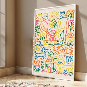 May include: A framed wall art print featuring a colorful, crayon-style illustration of a family, a house, a sun, flowers, and pets. The drawing uses vibrant blue, orange, pink, yellow, and green lines on a textured off-white background.
