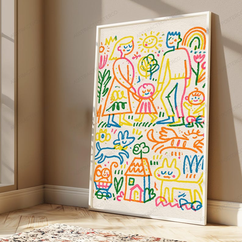 May include: A framed wall art print featuring a colorful, crayon-style illustration of a family, a house, a sun, flowers, and pets. The drawing uses vibrant blue, orange, pink, yellow, and green lines on a textured off-white background.