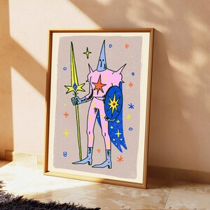 May include: A framed art print featuring a stylised figure in a pink suit with a pointed hood, holding a tall yellow spear and a blue shield. The figure is surrounded by colourful star icons against a textured light purple background.