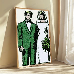 May include: A framed wall art print featuring a stylized illustration of a couple on their wedding day. The person on the left wears a green suit with a black bowtie, while the person on the right wears a white wedding dress and veil.