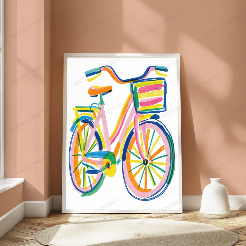May include: A framed art print featuring a colorful, abstract illustration of a bicycle. The bicycle is rendered with bold, expressive brushstrokes in shades of pink, orange, yellow, blue, and green, and includes a front basket with striped details.
