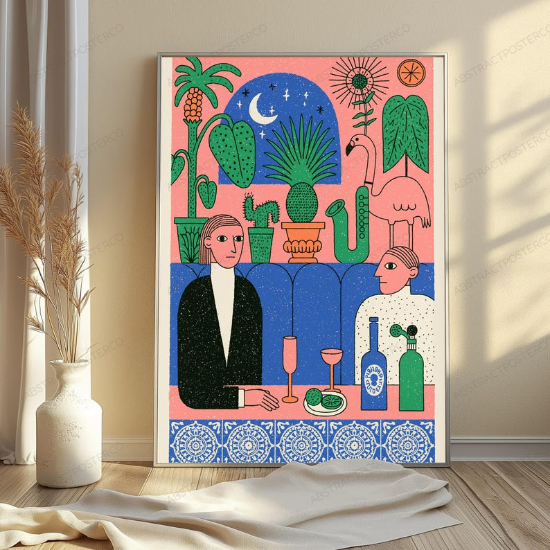 May include: A framed art print featuring a stylized illustration of two people sitting in a blue booth. The scene includes a pink flamingo, potted plants, a crescent moon, a saxophone, and two bottles on a table with a blue patterned tile border.