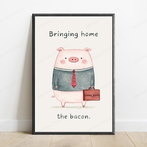 May include: A framed wall art print featuring a watercolor illustration of a pink pig dressed in a grey shirt and a red striped tie, holding a brown briefcase. The text above reads Bringing home and the text below reads the bacon.