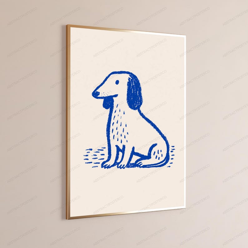 May include: A framed wall art print featuring a blue line drawing of a sitting dog on a cream-colored background. The illustration uses a textured, crayon-like stroke to depict the canine figure, which is centered within a thin gold metal frame.