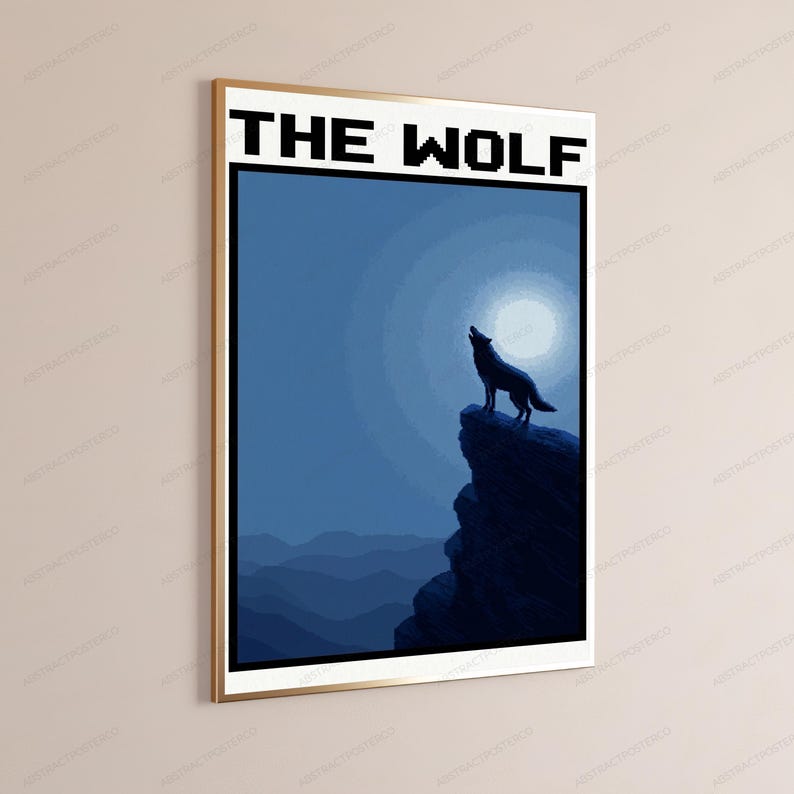 May include: A framed rectangular wall art print featuring a dark blue silhouette of a wolf standing on a rocky cliff against a bright full moon. The text THE WOLF is printed in a bold, black, pixelated font at the top of the white-bordered poster.