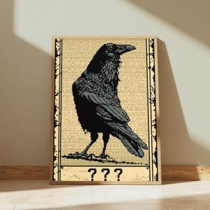May include: A framed pixel art print featuring a black raven standing in profile against a textured beige background. The artwork is enclosed in a light wood frame and includes the text ??? in a pixelated font at the bottom of the composition.