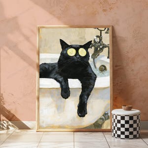 May include: A framed wall art print featuring a black cat relaxing in a white bathtub. The cat has two yellow cucumber slices placed over its eyes. A metallic faucet fixture is visible in the background of the tub, set against a neutral backdrop.