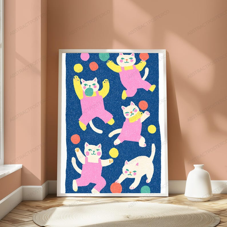 May include: A framed vertical art print featuring five white cats wearing pink overalls on a textured dark blue background. The cats are depicted in various playful poses, surrounded by scattered colorful circles in yellow, orange, pink, and teal.