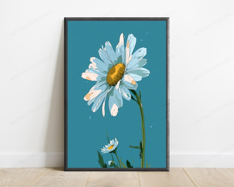 May include: A framed wall art print featuring a large, stylized daisy with light blue petals and a textured yellow center, set against a solid teal background. A smaller daisy bud appears at the bottom, connected by a green stem and leaves.