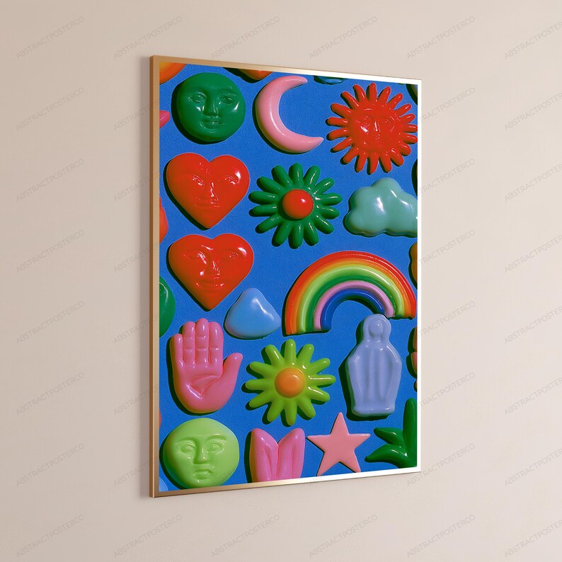 May include: A framed wall art print featuring a vibrant blue background covered in a repeating pattern of glossy, raised-style icons including green faces, red hearts, a pink crescent moon, a red sun, a rainbow, flowers, a hand, and a star.