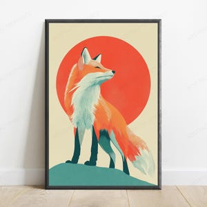 May include: A framed vertical wall art print featuring a stylised orange and white fox standing on a teal hill. Behind the fox is a large, solid red circle set against a cream-coloured background. The fox is looking towards the right side.