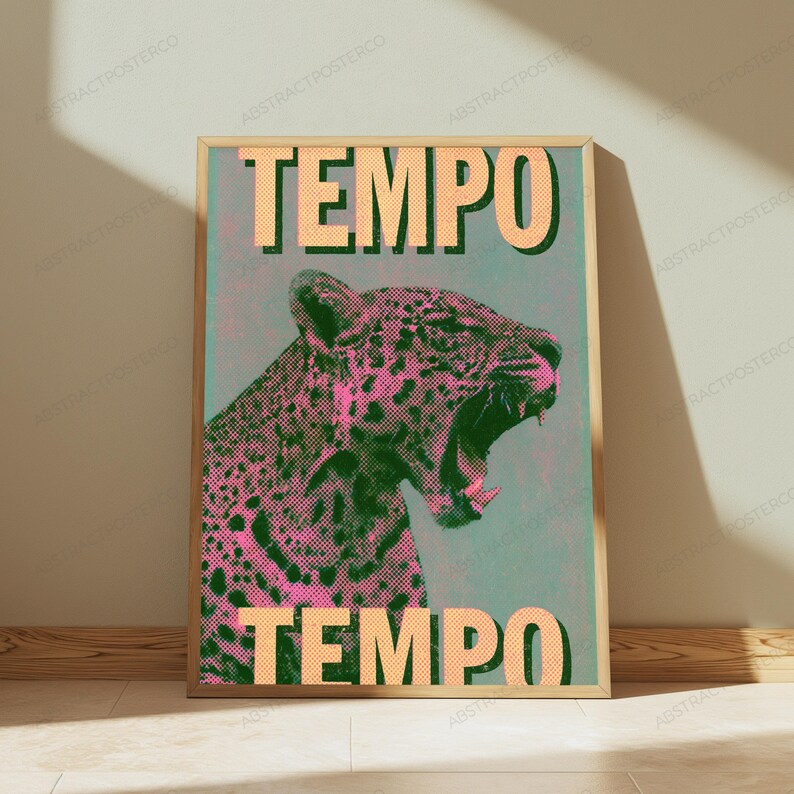 May include: A rectangular wall art print in a light wood frame featuring a stylized leopard with an open mouth. The leopard is rendered in pink and black halftone dots against a teal background. The word TEMPO appears in large beige letters.
