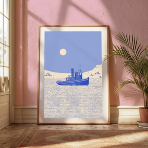 May include: A framed art print featuring a blue tugboat centered on a textured light yellow sea under a solid periwinkle sky with a pale yellow circular moon. The scene includes a distant shoreline with small structures under the blue sky.