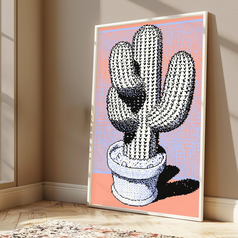 May include: A framed wall art print featuring a pixelated cactus in a pot. The cactus is rendered in black and white with a stippled texture. The background is a split design of light purple and peach orange, with a dark shadow cast to the right.