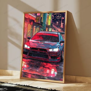 May include: A framed vertical wall art print depicting a dark grey sports car parked on a wet city street at night. The scene features vibrant red and yellow light reflections on the ground, with a red windshield banner on the vehicle.