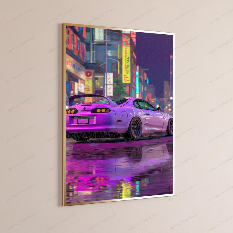May include: A framed vertical wall art print featuring a purple sports car parked on a wet, reflective surface at night. The background displays a blurred urban street scene with illuminated signs and buildings in shades of yellow and blue.