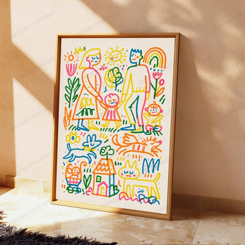 May include: A framed wall art print featuring a colorful, childlike line drawing of a family with two children, a house, a sun, a rainbow, and pets. The illustration uses vibrant orange, yellow, blue, green, and pink markers on a white background.
