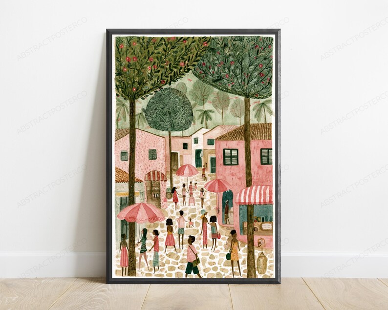 May include: A framed art print depicting a cobblestone street scene with pink buildings, tall green trees, and people walking under pink and white striped umbrellas. The illustration features a warm colour palette with soft textures and detailed foliage.