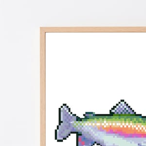 May include: A framed wall art piece featuring a pixel art illustration of a fish. The fish is rendered in a vibrant gradient of colors including purple, blue, green, yellow, and orange, set against a plain white background within a light wood frame.