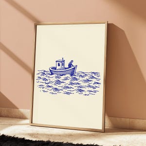 May include: A framed wall art print featuring a blue ink illustration on a cream background. The artwork depicts a small boat with a cabin floating on stylised, wavy water, with a single figure visible on the deck of the vessel.