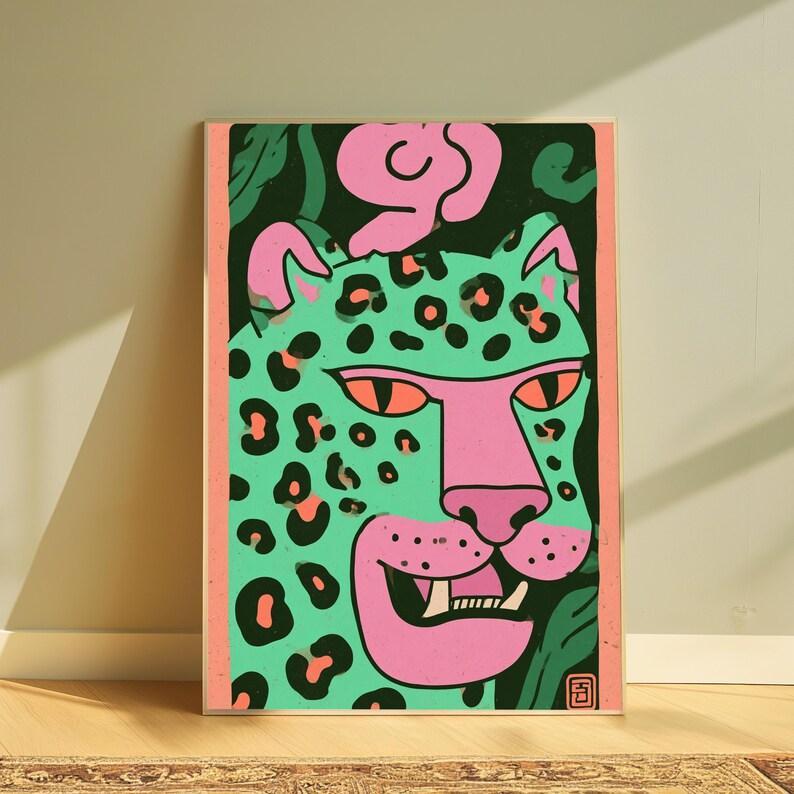 May include: A rectangular art print featuring a stylized leopard head in mint green with black spots and a pink snout, mouth, and ears. The leopard has orange eyes and visible teeth. The background is dark green with pink abstract shapes and a pink border.