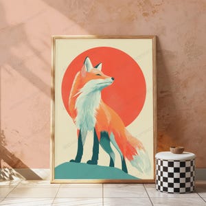 May include: A framed vertical wall art print featuring a stylised orange and white fox standing on a teal hill against a large solid red circular background. The fox is depicted in profile, facing right, with a cream-coloured chest and dark legs.