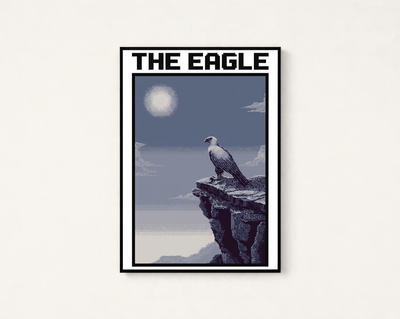 May include: A rectangular wall art print featuring a pixel art style eagle perched on a rocky cliff edge. The scene includes a pale sun in a blue sky with clouds and the text THE EAGLE printed in bold black capital letters at the top.