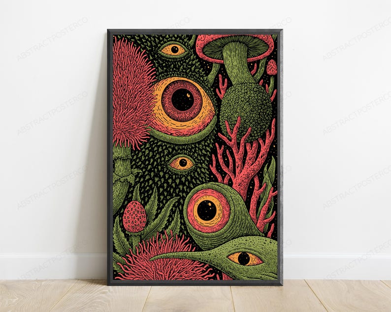 May include: A framed rectangular wall art print featuring a dense, dark illustration of multiple large, wide-open eyes with orange irises and black pupils, interspersed with textured green foliage, pink spiky flowers, and coral-like structures.