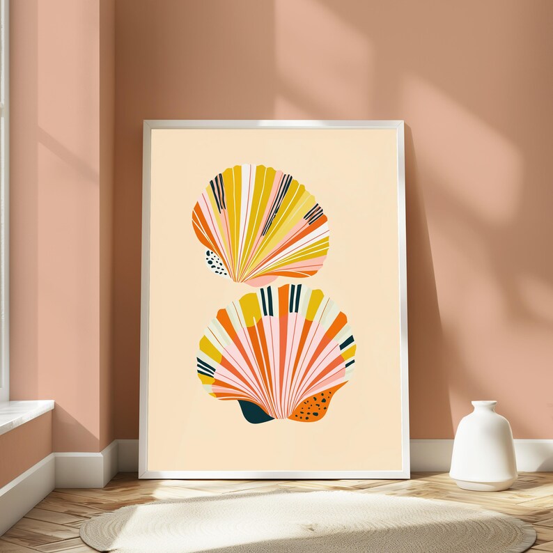 May include: A framed wall art print featuring two stylised seashells stacked vertically against a light cream background. The shells are illustrated with vibrant stripes of mustard yellow, coral pink, white, and dark navy blue, including small black dots.