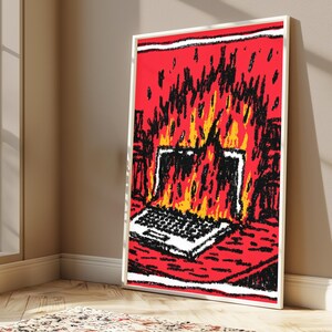 May include: A framed vertical art print featuring a stylized, hand-drawn illustration of a laptop engulfed in bright yellow and orange flames against a vibrant red background, with bold black outlines and textured, scribbled shading throughout.