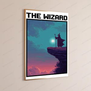 May include: A framed vertical wall art print titled THE WIZARD in pixelated black font. The illustration depicts a dark silhouette of a robed figure holding a staff, standing on a cliff edge against a teal sky with a bright moon and pink clouds.