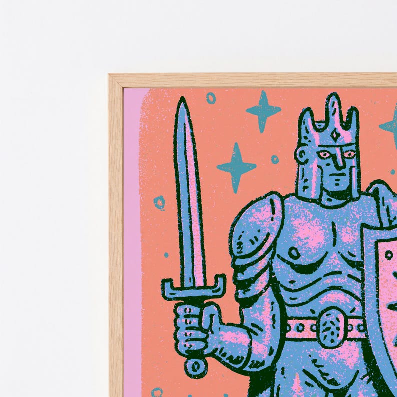 May include: A framed art print featuring a stylized illustration of a knight in blue armor holding a sword and shield. The background is a solid peach color with blue star shapes. The knight wears a crown and has a textured, graphic appearance.