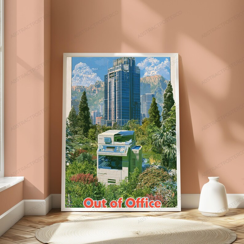 May include: A rectangular wall art print featuring a light-colored office photocopier situated in a lush green garden with tall trees and a large skyscraper in the background under a blue sky. The text Out of Office is printed in red at the bottom.
