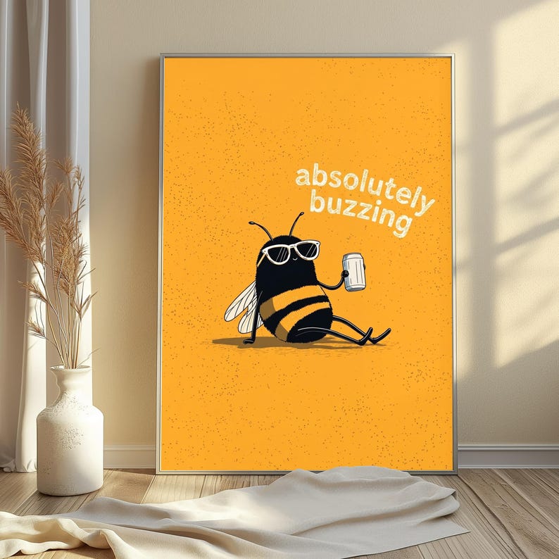 May include: A rectangular wall art print featuring a cartoon bee with black and yellow stripes, wearing white-rimmed sunglasses, sitting and holding a silver can. The background is solid orange with the white text absolutely buzzing.