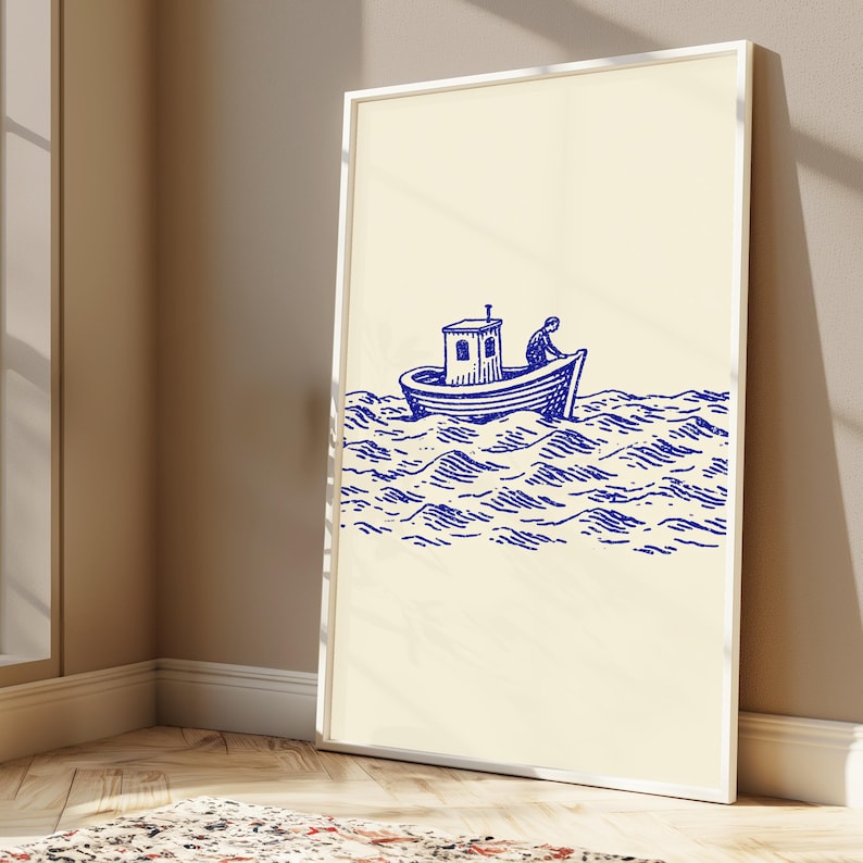 May include: A framed wall art print featuring a blue ink illustration on a cream background. The artwork depicts a small boat with a cabin and a single figure on board, navigating through stylised, wavy ocean water in a nautical line art style.