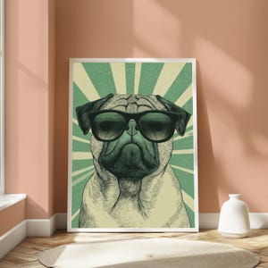 May include: A framed wall art print featuring a stylized illustration of a pug dog wearing black sunglasses. The background consists of a green and cream-colored sunburst pattern with a distressed, vintage-inspired texture throughout the image.