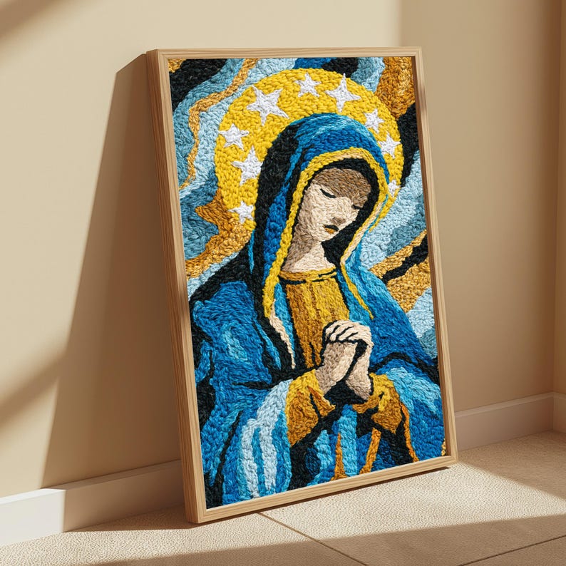 May include: A framed textile wall art piece featuring a textured, punch needle style depiction of a figure with hands clasped in prayer. The figure wears a blue and gold head covering and robe, set against a background of swirling blue and gold.