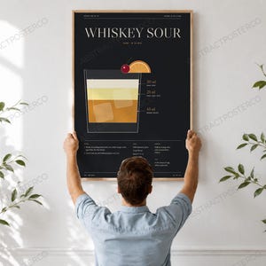Whiskey Sour Cocktail Recipe Print, held up in a room