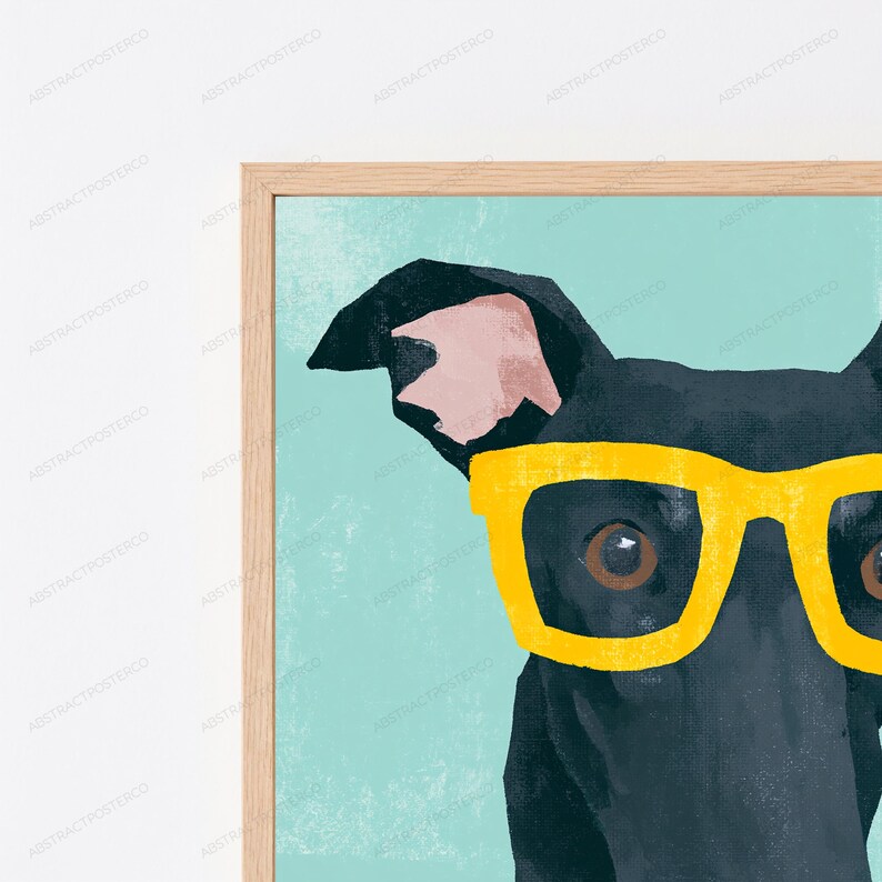 K&ouml;nnte beinhalten: Ein gerahmter Wandkunstdruck mit einer Nahaufnahme eines schwarzen Hundes, der eine leuchtend gelbe Brille vor einem strukturierten hellblauen Hintergrund tr&auml;gt. Der Hund hat ein sichtbares Ohr mit rosa Innenseite und dunkelbraune Augen.