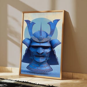 May include: A framed wall art print featuring a vibrant blue samurai helmet with a prominent crest and face mask. The helmet is centered against a light blue circular background and a pale, textured backdrop, encased in a thin gold frame.