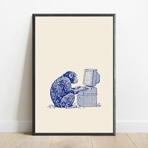 May include: A framed wall art print featuring a blue ink illustration of a chimpanzee sitting at a vintage computer desk and typing on a keyboard. The artwork is set against a solid cream-colored background, enclosed in a thin black frame.
