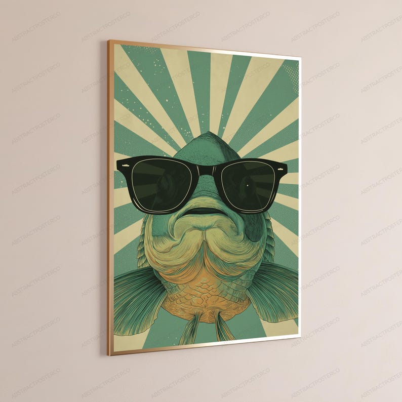 May include: A rectangular wall art print featuring a stylized illustration of a fish wearing large black sunglasses. The fish is centered against a background of radiating teal and cream-colored sunburst stripes, framed in a thin gold border.