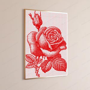 Pode incluir: Uma impress&atilde;o de arte de parede emoldurada apresentando uma rosa vermelha e um bot&atilde;o de rosa renderizados em um padr&atilde;o de pontos sobre um fundo branco. A obra exibe uma composi&ccedil;&atilde;o floral detalhada com uma rosa em flor, um bot&atilde;o e folhas.